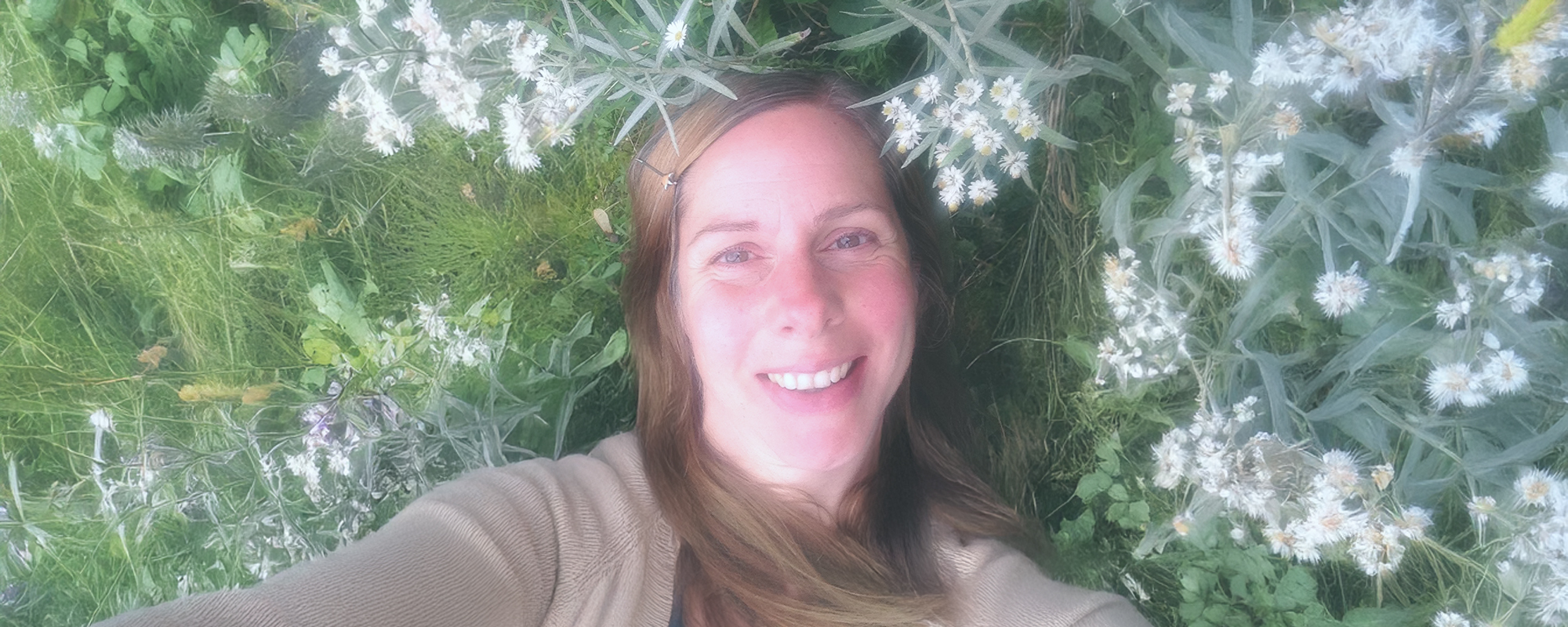 woman-lying-in-meadow-seen-from-above